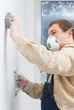Young man builder polishing the wall. house environment theme. Young man builder polishing the wall. house environment theme.