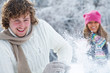 Couple playing snowballs