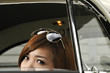girl peeping from inside of an antique car