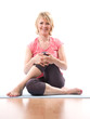 Young smiling woman doing gym with crossed legs