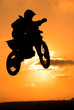 A biker makes a big jump in the sky. A biker makes a big jump in the sky.