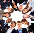 Group of business people standing in huddle, smiling,