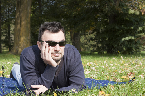 Photo: Young Adult Relaxing in the Park during a Weekend Afternoon Young Adult Relaxing in the Park during a Weekend Afternoon