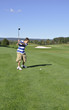 young boy on golf course young boy on golf course