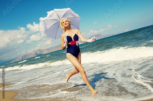 Photo: Attractive blond woman running in the sea Attractive blond woman running in the sea