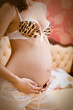 Pregnant woman sitting on a bed