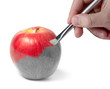 Male hand painting a fresh red wet apple