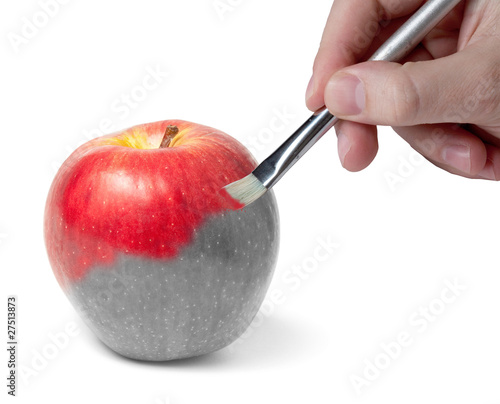 Photo: Male hand painting a fresh red wet apple Male hand painting a fresh red wet apple