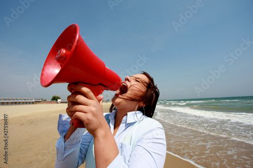 Photo: Young Woman Using Loud Hailer. Model Released Young Woman Using Loud Hailer. Model Released