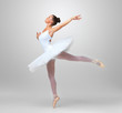 Beautiful ballet dancer practicing against white background