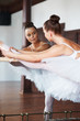 Ballerina dancing at ballet bar in front of a mirror