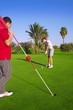 golf woman putting gol ball and man holds flag golf woman putting gol ball and man holds flag