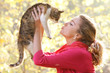 young attractive girl with cat on natural background young attractive girl with cat on natural background