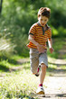 Young boy running in nature