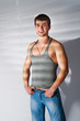 muscular man in grey top and jeans muscular man in grey top and jeans