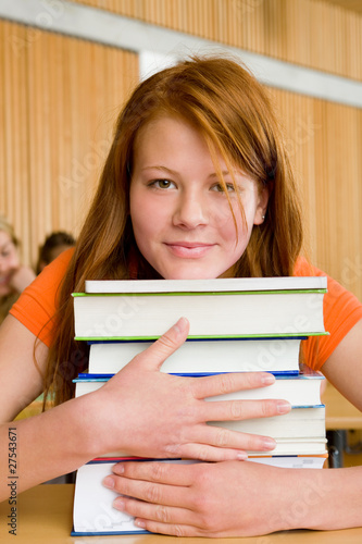 Photo: Girl in class with books Girl in class with books