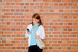 Photo: Young university student looking at mobile phone Young university student looking at mobile phone
