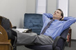 Photo: Businessman relaxing at his desk Businessman relaxing at his desk