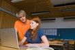 Teens studying with a computer in the library