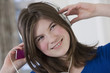 Teenage girl using earphones with her MP3