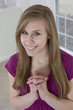 Photo: Teenage girl clasping her hands and smiling Teenage girl clasping her hands and smiling