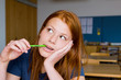 Photo: Portrait of a young woman holding a pencil Portrait of a young woman holding a pencil