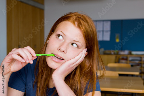 Photo: Portrait of a young woman holding a pencil Portrait of a young woman holding a pencil