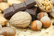 bar of chocolate and nuts on a wicker mat bar of chocolate and nuts on a wicker mat