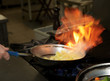 Chef is making flambe sauce Chef is making flambe sauce
