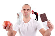 Photo: man choosing apple or chocolate,between devil and angel man choosing apple or chocolate,between devil and angel