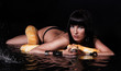 Beautiful woman lying with Python in water