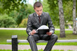 business man working with papers at park. Student