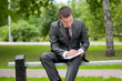 business man working with papers at park. Student