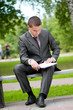 business man working with papers at park. Student