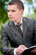 business man working with papers at park. Student