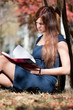 business woman reviewing diary at city park