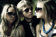 Fashion young guys and girls sitting together and having fun Fashion young guys and girls sitting together and having fun