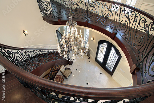 Photo: Curved stairway leading down into foyer Curved stairway leading down into foyer