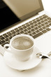 Cappuccino cup on laptop Cappuccino cup on laptop