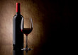 bottle with red wine and glass and grapes