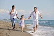 happy young  family have fun on beach