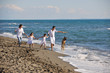 happy family playing with dog on beach happy family playing with dog on beach