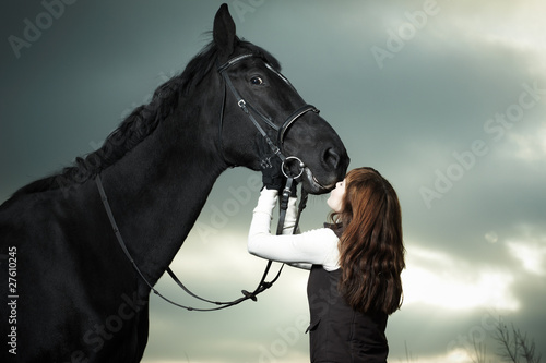 Photo: Beautiful young woman with a black horse Beautiful young woman with a black horse