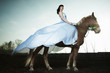 Photo: Beautiful woman riding on a brown horse Beautiful woman riding on a brown horse