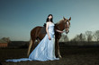 Photo: Beautiful young woman with a brown horse Beautiful young woman with a brown horse