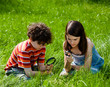 Kids looking through magnifying glass Kids looking through magnifying glass