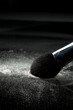 detail of a powder brush with white loose powder