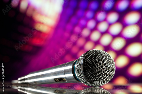 Photo: microphone against purple disco background microphone against purple disco background