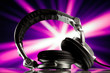 dj headphones against purple rays background