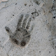 grungy hand print in concrete floor grungy hand print in concrete floor